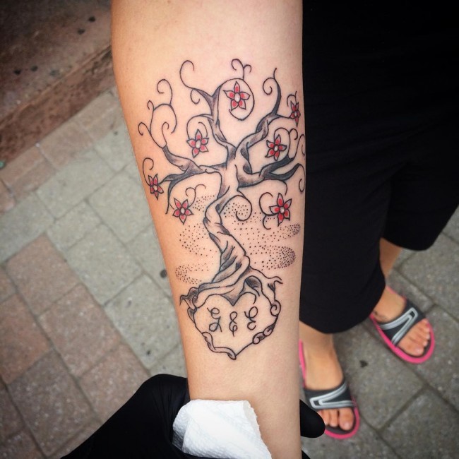 Einfaches hausgemachtes Tattoo von blühendem Baum mit Schriftzug auf Unterarm