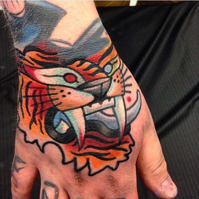 Simple homemade like colored hand tattoo of tiger