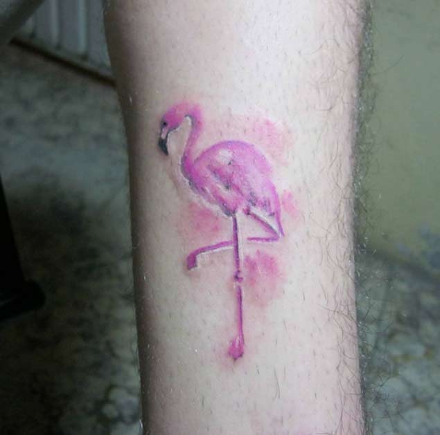 Simple homemade like tiny pink flamingo tattoo on leg