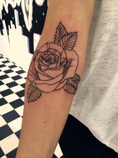 Simple homemade like uncolored rose tattoo on arm