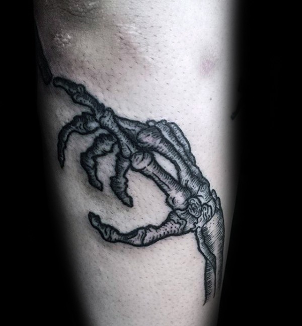 Simple homemade style detailed arm tattoo of bone hand