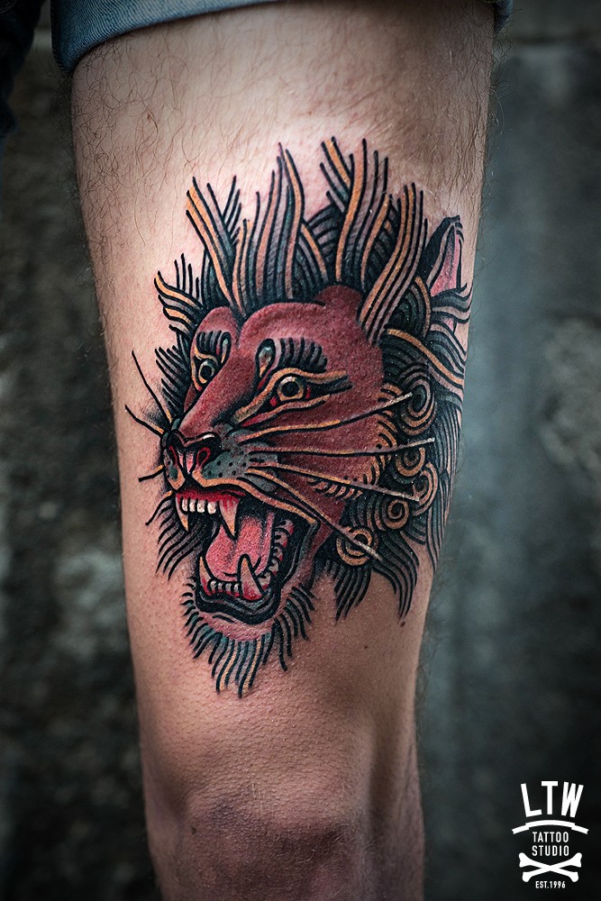 Simple illustrative style thigh tattoo of roaring lion