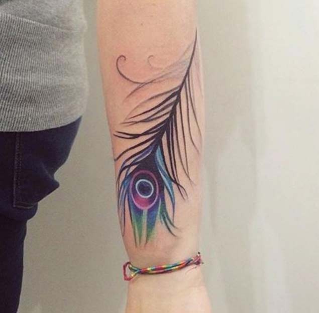 Simple little forearm tattoo of multicolored peacock feather