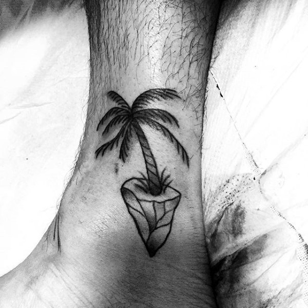 Simple little homemade black ink palm tree tattoo on ankle