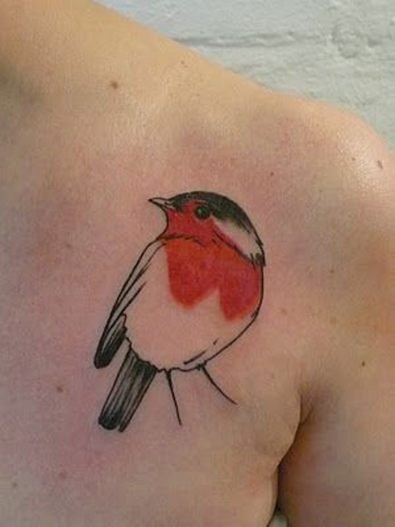 Simple little tiny colored bird tattoo on shoulder