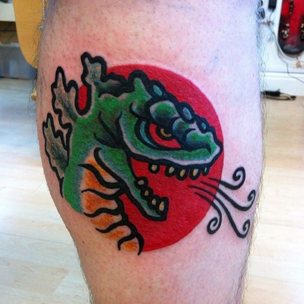 Simple multicolored homemade Godzilla tattoo on leg