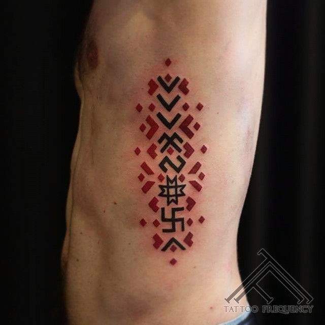 Simple multicolored side tattoo of mystical ornaments