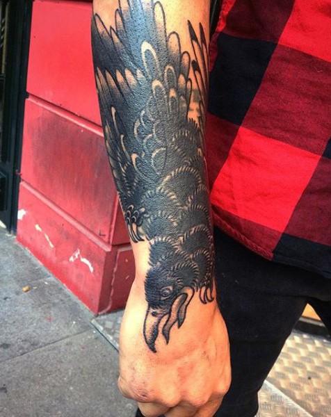 Simple old school black ink crow tattoo on wrist
