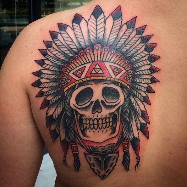 Simple old school style colorful Indian skull tattoo on back stylized with helmet from feather