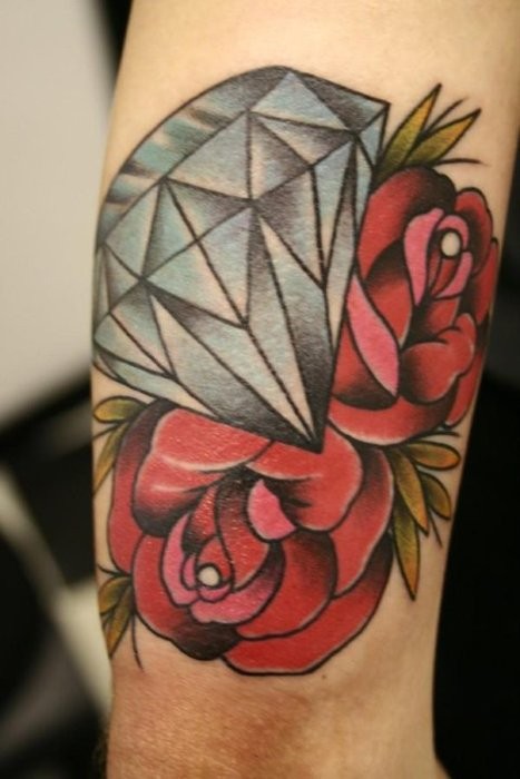 Simple painted and colored diamond with roses tattoo on arm