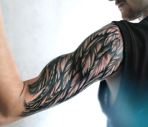 Simple painted black and white wing tattoo on sleeve