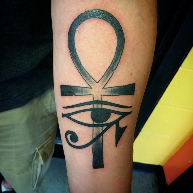 Simple painted black ink forearm tattoo of various Egypt symbols