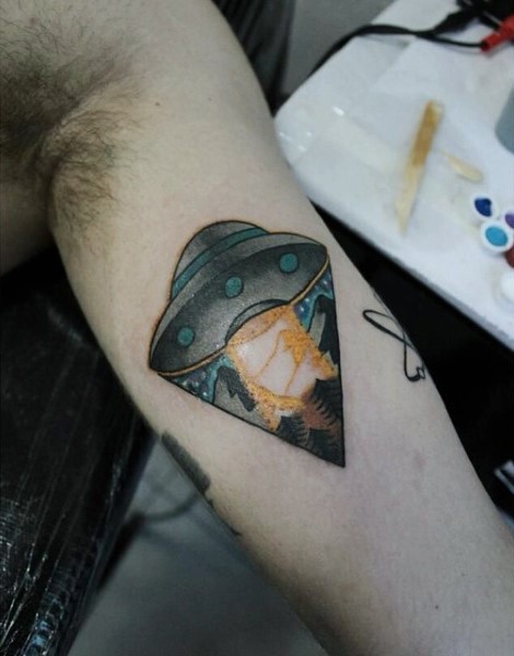 Simple painted colorful tiny alien ship tattoo on arm