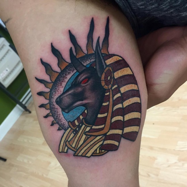 Simple painted homemade like colored biceps tattoo of Egypt Anubis God