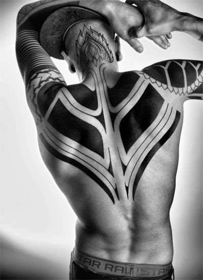 Simple painted massive black ink tribal ornaments tattoo on sleeve and upper back