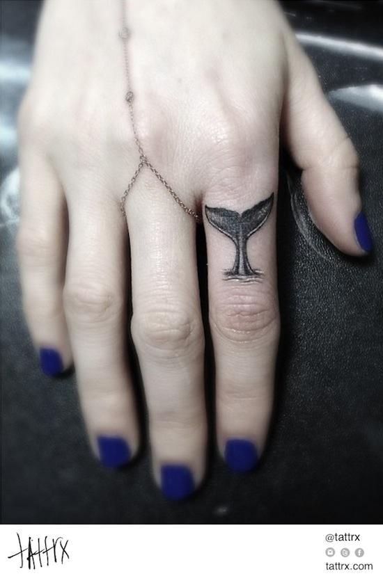Simple painted tiny black ink wale tail tattoo on finger
