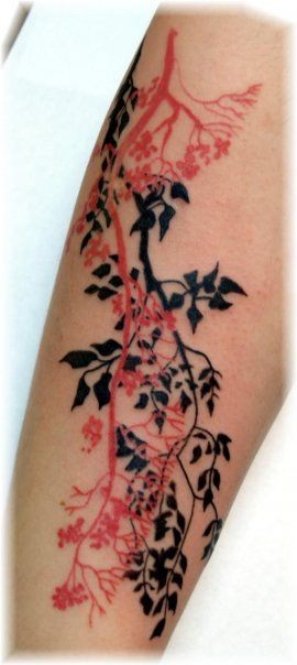 Simple red and black colored tree branches tattoo on arm