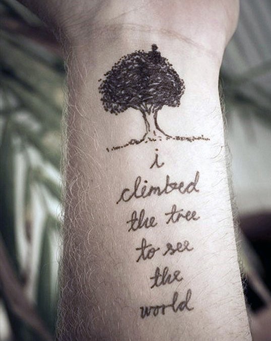 Simple romantic style black ink tree with lettering tattoo on wrist