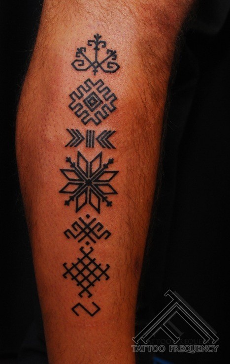 Simple small black ink tattoo of various symbols