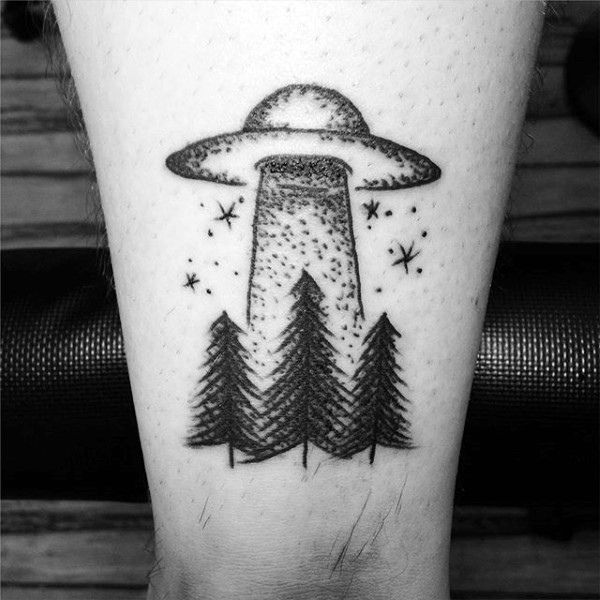 Simple tiny black ink homemade like alien ship with forest tattoo on ankle