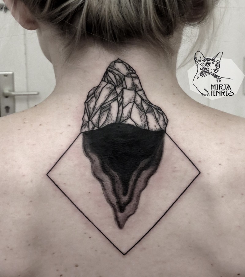 Simple unfinished black ink back tattoo of small rock