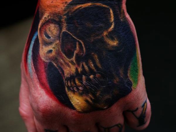 Simple usual black ink hand tattoo of human skull