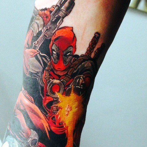 Simple usual looking colored tattoo of Deadpool with pistols