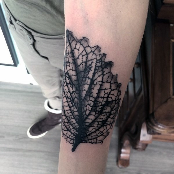 Simple very detailed black and white leaf tattoo on arm
