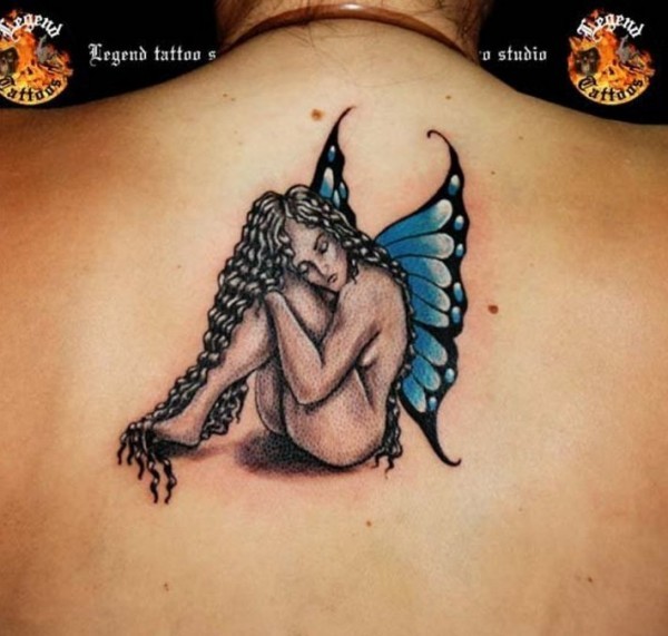 Sitting fairy with long black hair tattoo on back