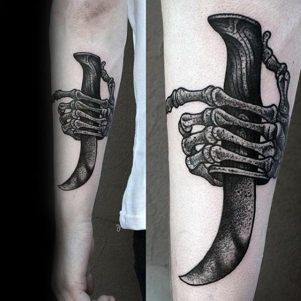Skeleton hand with sharp dagger tattoo on forearm in old school style
