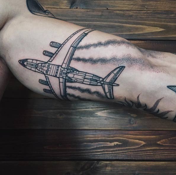 Sketch like black ink biceps tattoo of big flying passenger plane