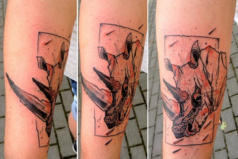 Sketch style black colored rhino head tattoo on forearm
