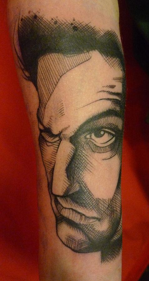 Sketch style black ink arm tattoo of big man face