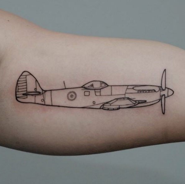 Sketch style black ink biceps tattoo of WW2 fighter plane