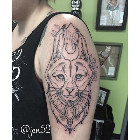Sketch style black ink shoulder tattoo of saint caracal with jewelry