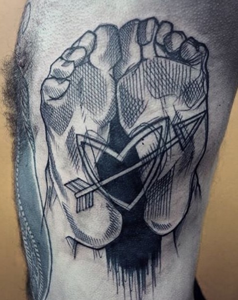 Sketch style black ink side tattoo of human legs with heart and arrow