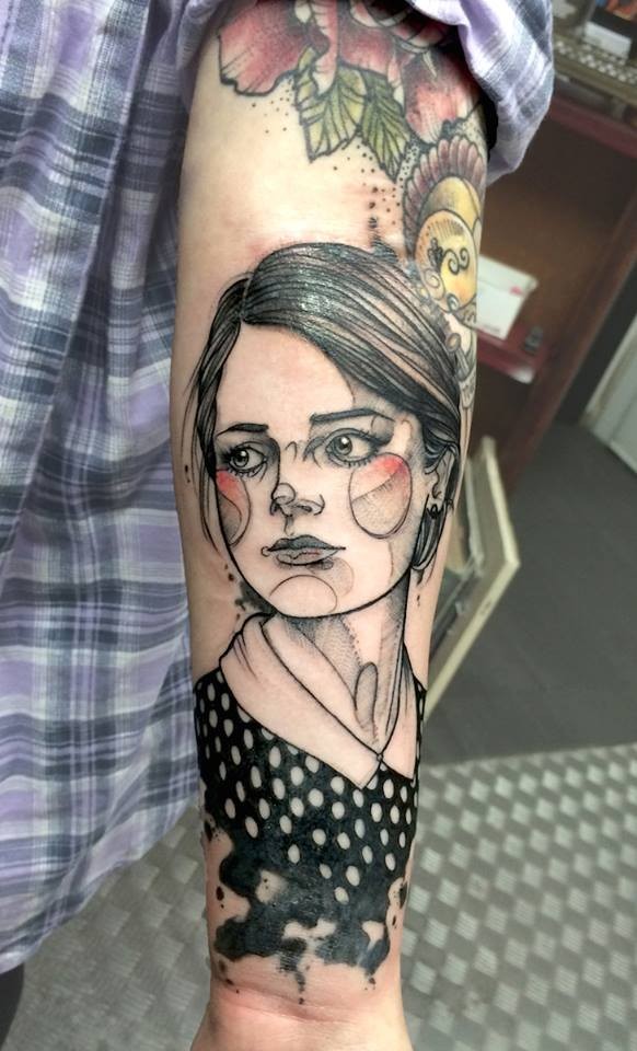 Sketch style colored arm tattoo of woman face