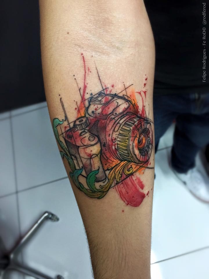 Sketch style colored forearm tattoo of modern camera