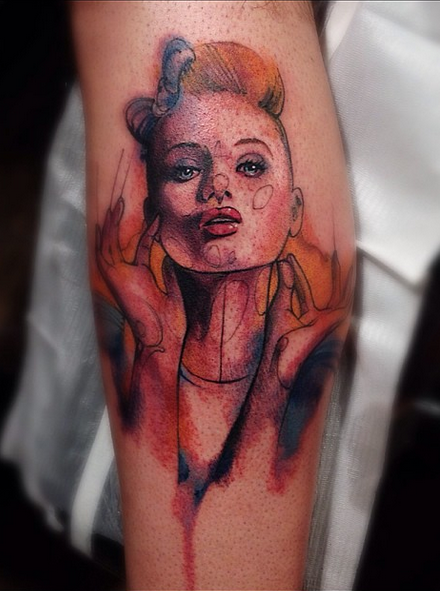 Sketch style colored funny woman face tattoo on leg - Tattooimages.biz