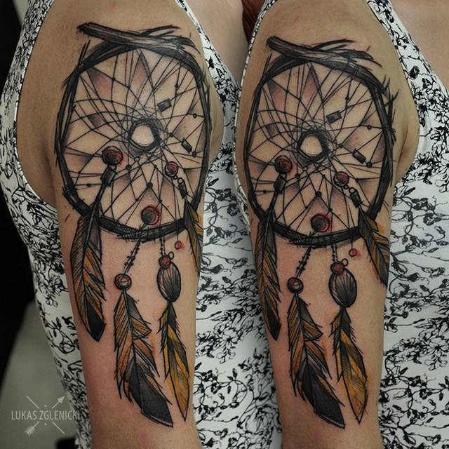Sketch style colored shoulder tattoo of dream catcher