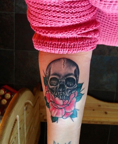 Skull with pink rose forearm tattoo