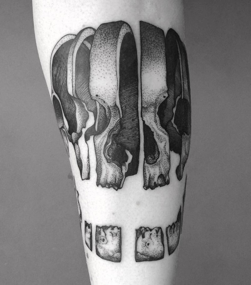 Sliced human skull pieces tattoo in engraving style with dotted work and volume details