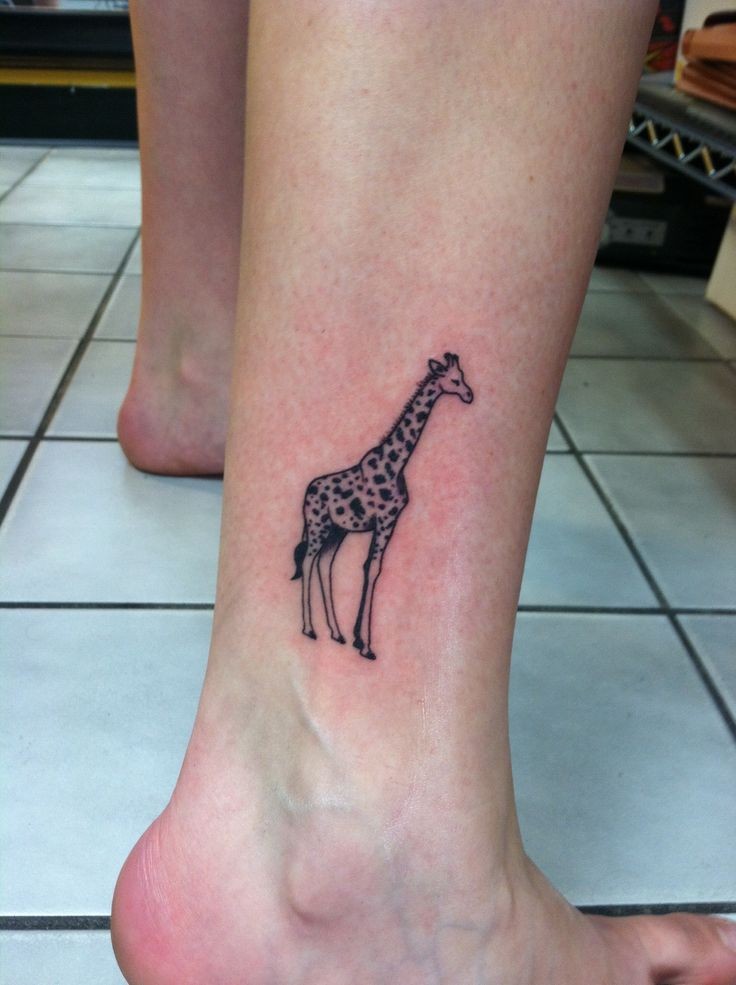 Small pretty giraffe tattoo on leg