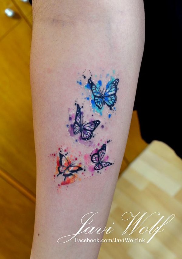 Small beautiful looking colored forearm tattoo of flying butterflies