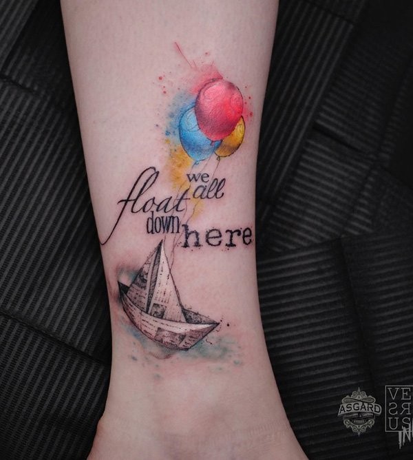 Small beautiful looking leg tattoo of paper ship with lettering and balloons