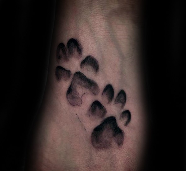 Small black ink animal paw prints