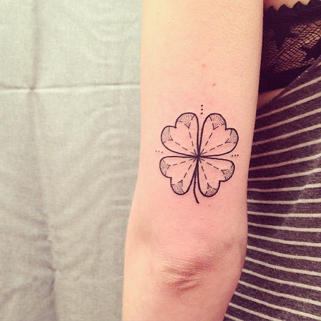 Small black ink arm tattoo of clover