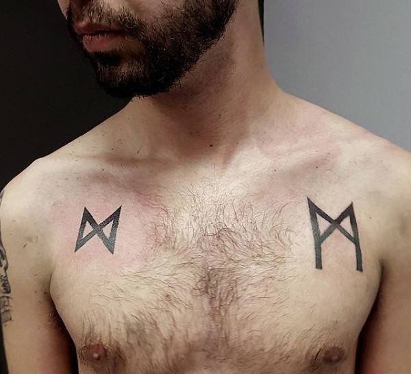 Small black ink chest tattoo of interesting symbols