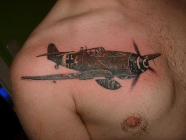 Small black ink chest tattoo of very detailed WW2 fighter plane