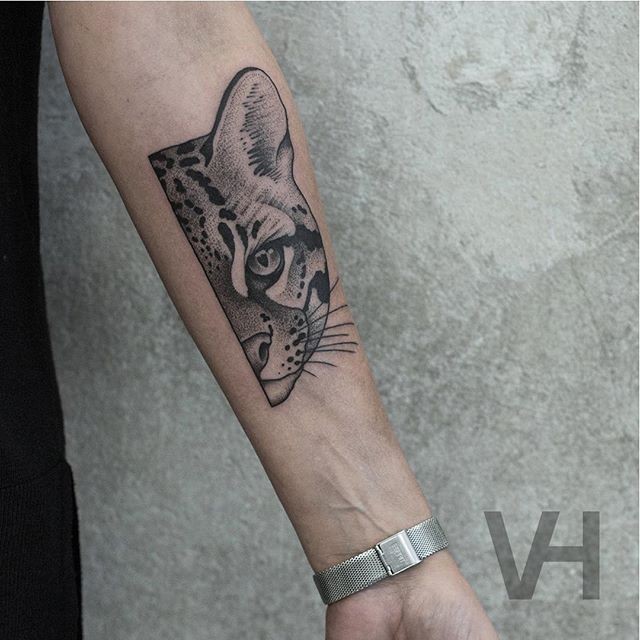 Small black ink  forearm tattoo of small wild cat by Valentin Hirsch